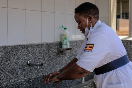 An Ugandan healthcare worker washing her hands